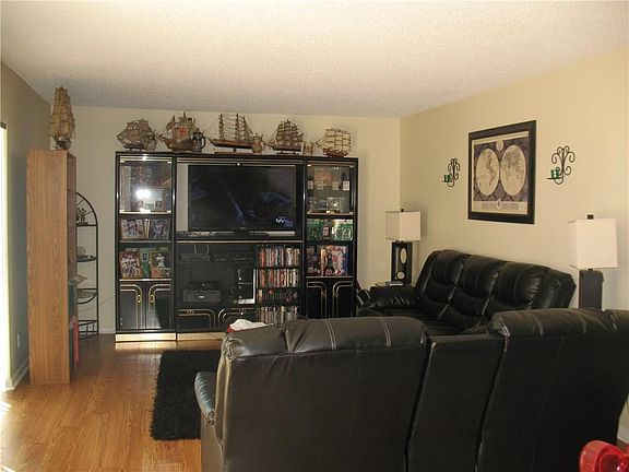 Living room has laminate wood flooring.