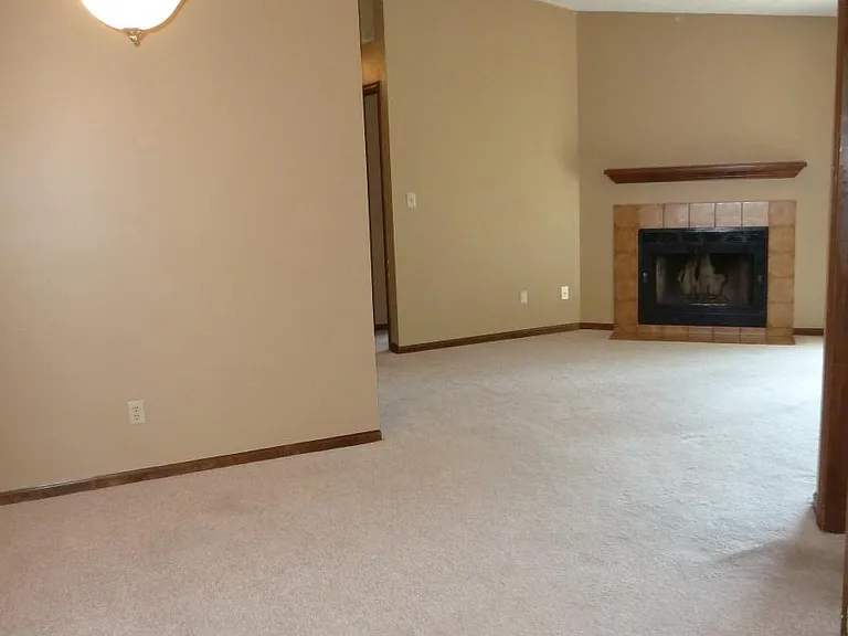 from front door through dining room and living room to fireplace. patio door to right of fireplace. Kitchen on other side of wall on left. Split floor plan. Master door just to the right of the view, and you can see the second bedroom door just past the