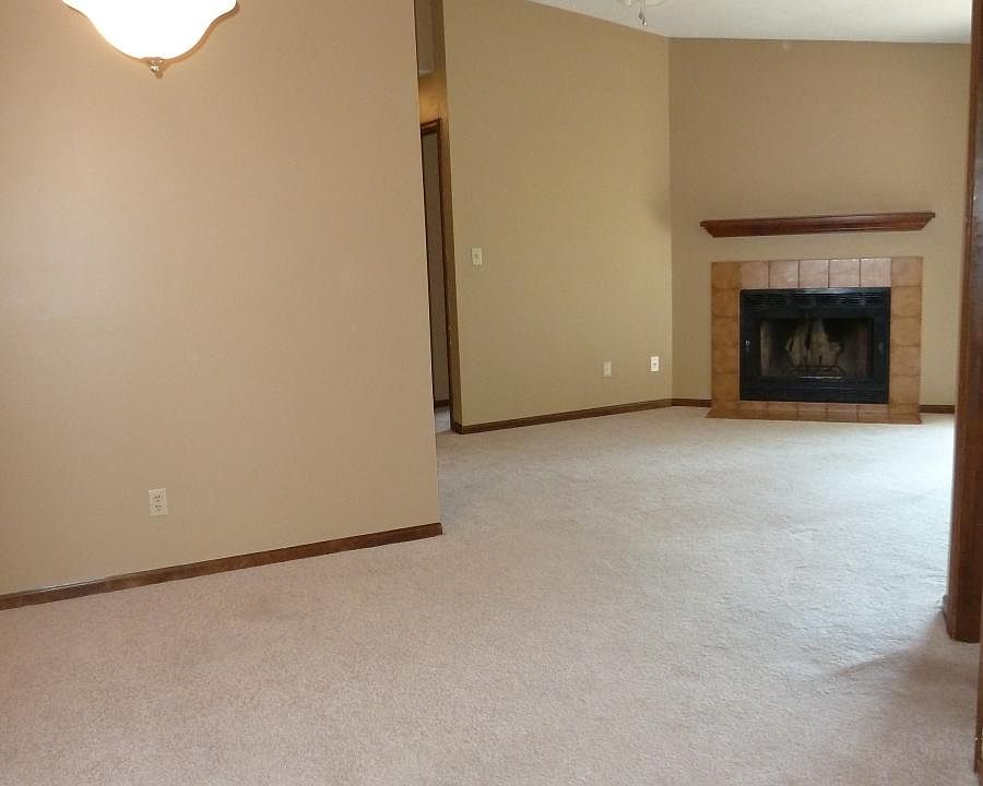 from front door through dining room and living room to fireplace. patio door to right of fireplace. Kitchen on other side of wall on left. Split floor plan. Master door just to the right of the view, and you can see the second bedroom door just past the