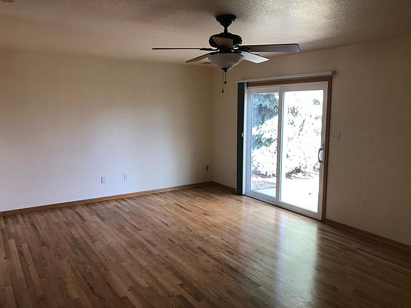 Lower living room leads out to the fenced back yard