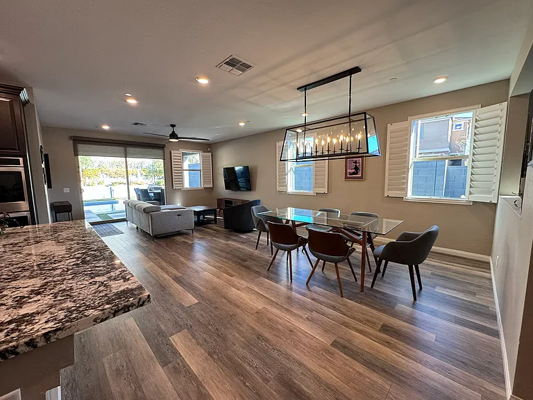 Open concept layout -- main area showing dining room, living room and edge of kitchen counter.