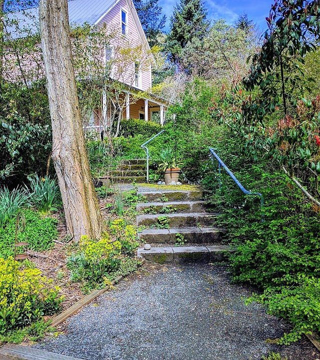 East face of house from parking, Living room beneath porch. Bedrooms above.