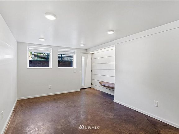Front Living Room with large windows w/ garden view.