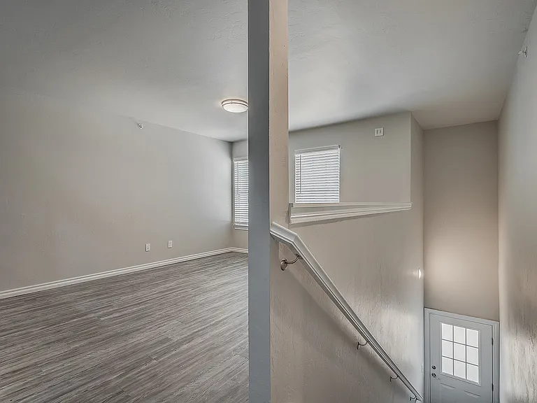 Explore the elegance of this entryway and the spaciousness of the adjacent room.