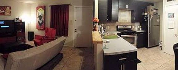Panorama of living, kitchen, and dining rooms.