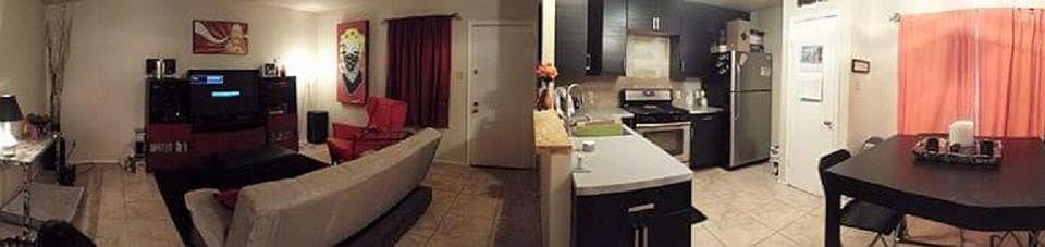Panorama of living, kitchen, and dining rooms.