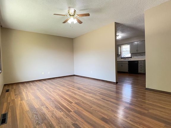 Living Room view from Front Door entrance, with Picture Window and View into Kitchen