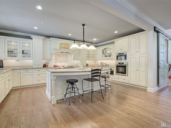 Chef's kitchen has an 8' island with prep sink. Wolf, Miele & Sub-zero appliances. Convection oven, microwave, vegetable steamer