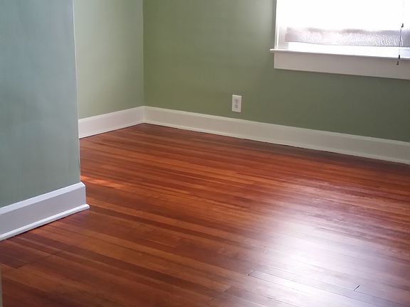 bedroom with newly refinished wood floors, new windows and b