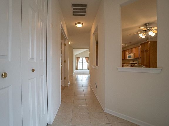 VIEW FROM FOYER OF KITCHEN, DEN & LARGE GREAT ROOM W/SOARING CEILING AND LOADS OF NATURAL LIGHT!