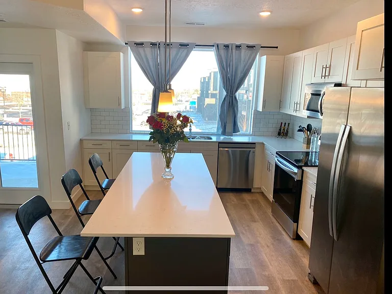 Large kitchen with refrigerator, range oven, microwave, dishwasher, Stainless steel sink and disposal.