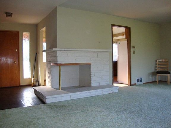 Living room with fireplace and dinning area! Hard wood floors under carpet!