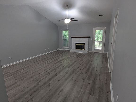 Living room with ceiling fan and natural gas fireplace