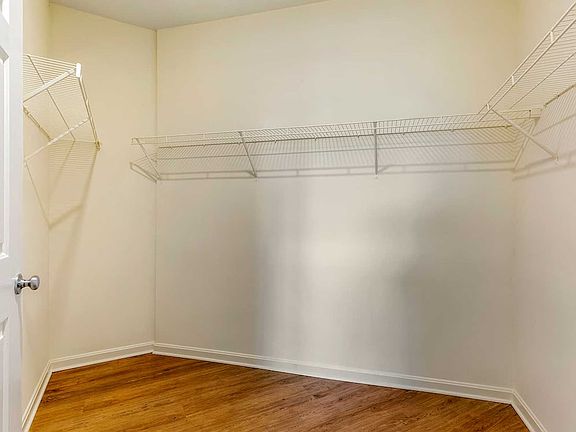 Walk-in closet with linen racks and storage space