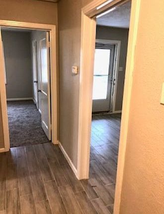 Hallway looking into front bedroom and living room to the right
