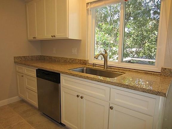 Sunny, bright kitchen looks onto patio