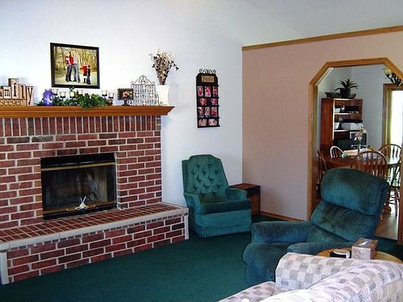 Living room complete with beautiful fireplace. You choose your carpet!