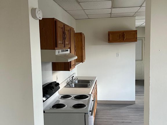 Kitchen countertop, sink, and stove.
