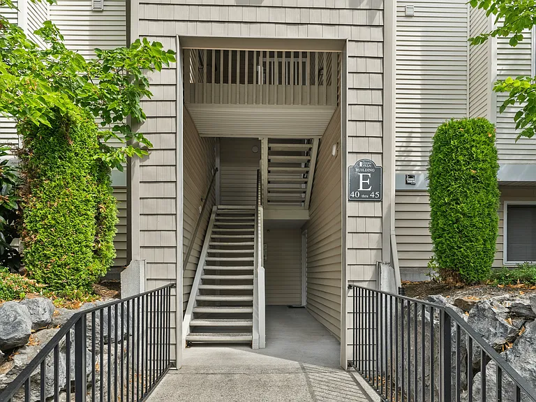 Convenient stairwell access at Building E with well-maintained surroundings.