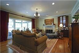 Family Room with fireplace, recessed lighting, hardwoods, breakfast bar, and l