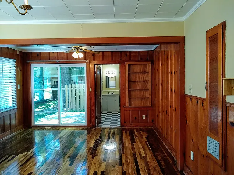 Lovely dining area with sliding glass doors to back deck. Notice the built-in bookshelves too!