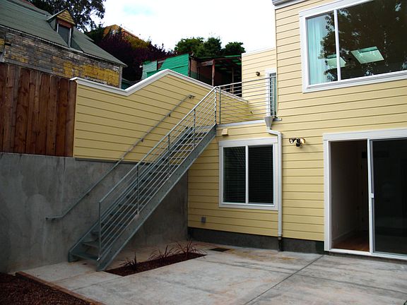 Exterior view : Stairs from deck to lower Patio and garden