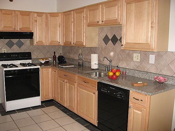 Kitchen with maple cabinets, granite countertops, tile backsplash, undermount sink, newer appliances
