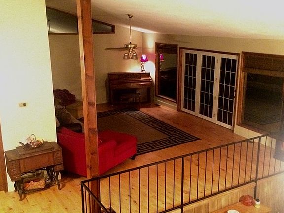 Living Room From Top of Stairs
						:
						A lovely place for brides to begin their march...or to launch paper airplanes.