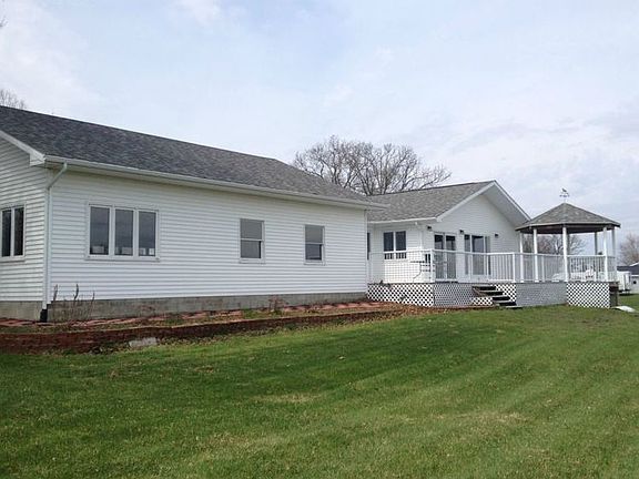 Back view of the house showing the huge deck with a Gazebo. You access it through a new sliding glass door off of the Great room.