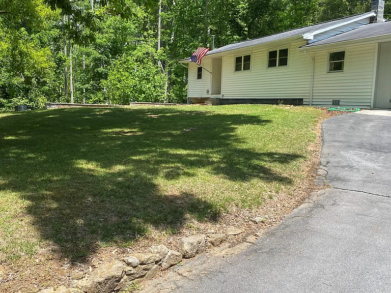 Spacious yard and plenty of shade for a picnic.
