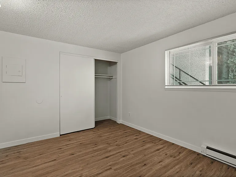 Cozy bedroom with modern flooring and ample closet space. Cozy bedroom with modern flooring and ample closet space.