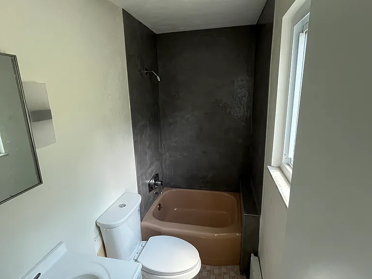 Small bathroom that is accessed from front bedroom.