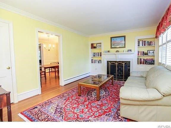 Formal living room with fireplace, custom built ins, mouldings &