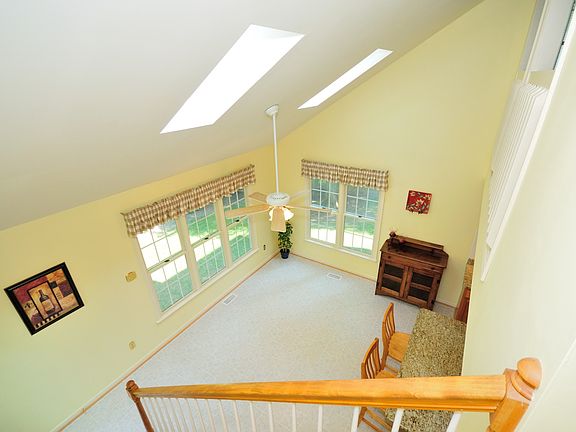 Open & Airy Eat-In Kitchen offers Vaulted Ceilings w/ Skylights