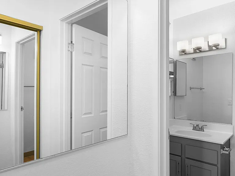 Vanity mirror in the primary bedroom. Looking into the renovated Primary bathroom.