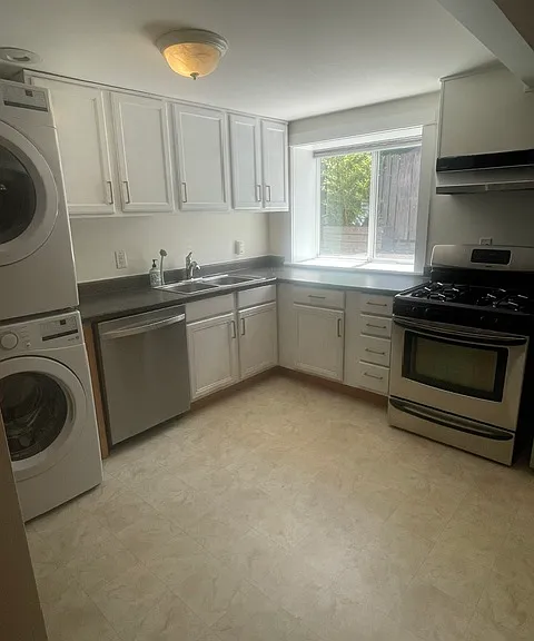 large kitchen with stacked washer and dryer.
