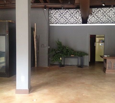 Stained concrete floor with high loft style ceiling.