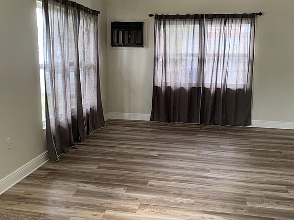 Left view from front door into Living room entry, with new window treatments.