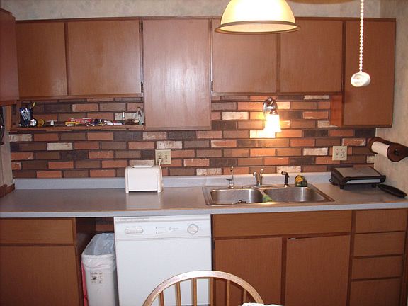 Featuring disposal, dishwasher, and formica counters.