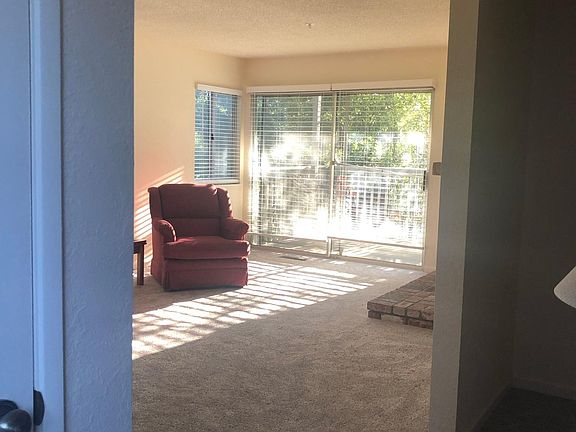 At the open front door looking into the living room. Morning sunshine noted.