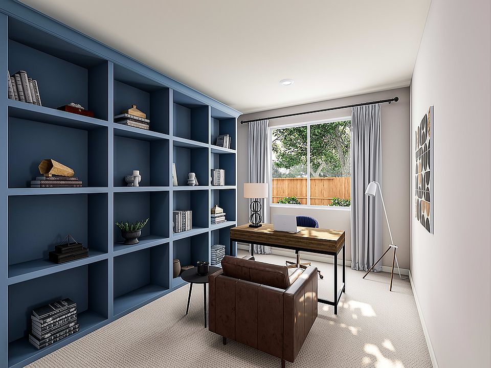 A modern and minimalist home office space with a large built-in bookshelf in a deep blue color, a wo