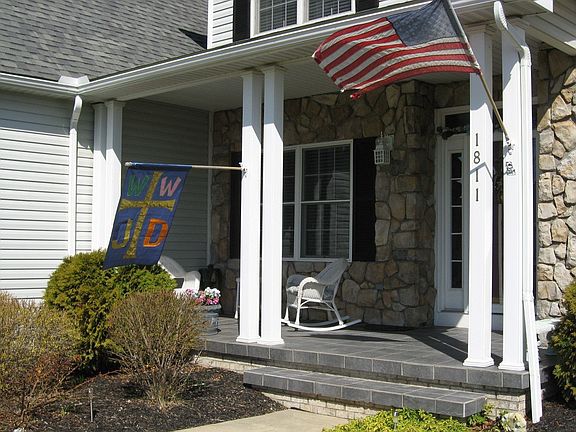 A wonderful front porch with slate floor invites you, your family, & friends.