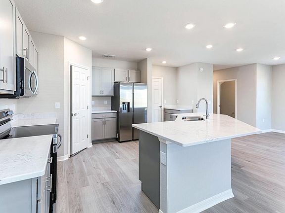 Enjoy an open kitchen with a counter-height butterfly island and walk-in pantry - Seabrooke ll home