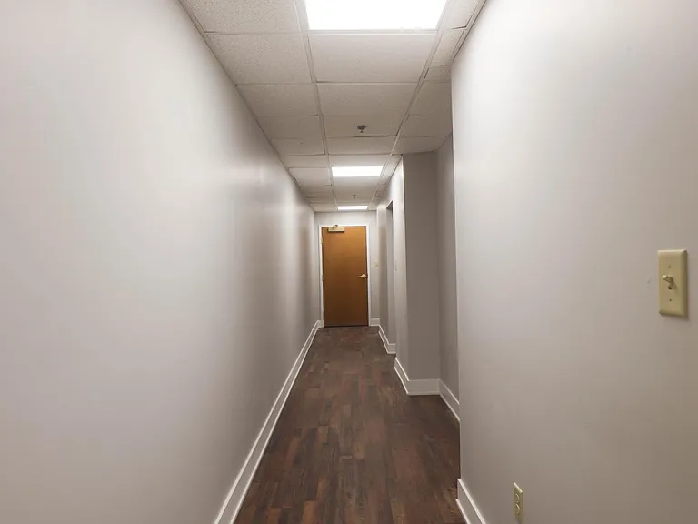 Front door to apt & hallway from kitchen/dining/1st bedroom down to 2nd onsuite bedroom.