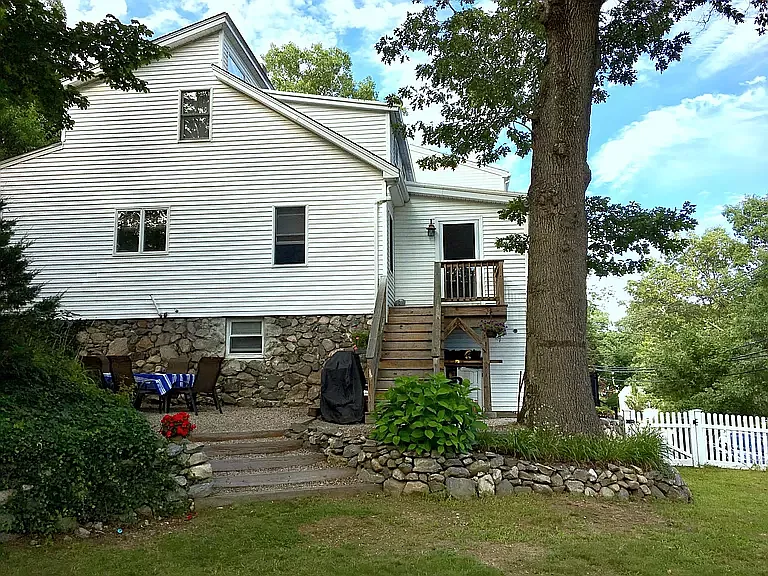 main entrance on side of home, patio, and yard.