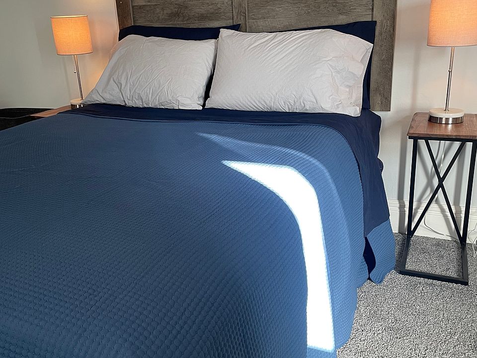 Primary bedroom queen bed with bedside usb ported lamps.