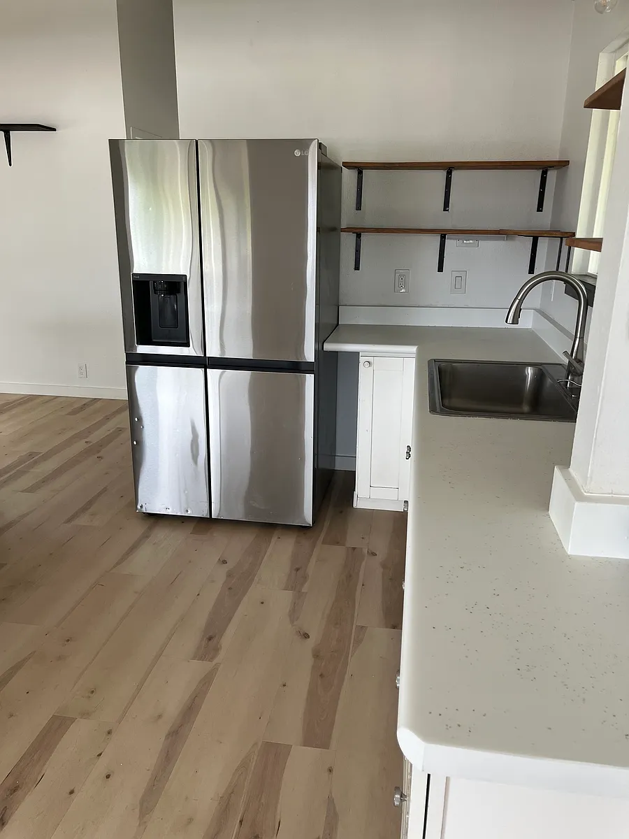 Open concept kitchen. Open shelving. Stainless steel refrigerator with ice maker and water dispenser. - 303 Niihau St