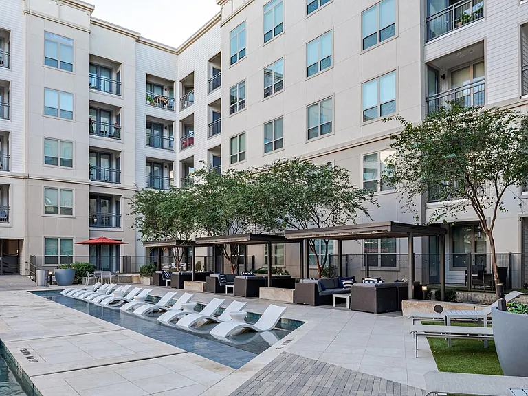 Outdoor Courtyard Featuring Shaded Seating and Stylish Poolside Vibe