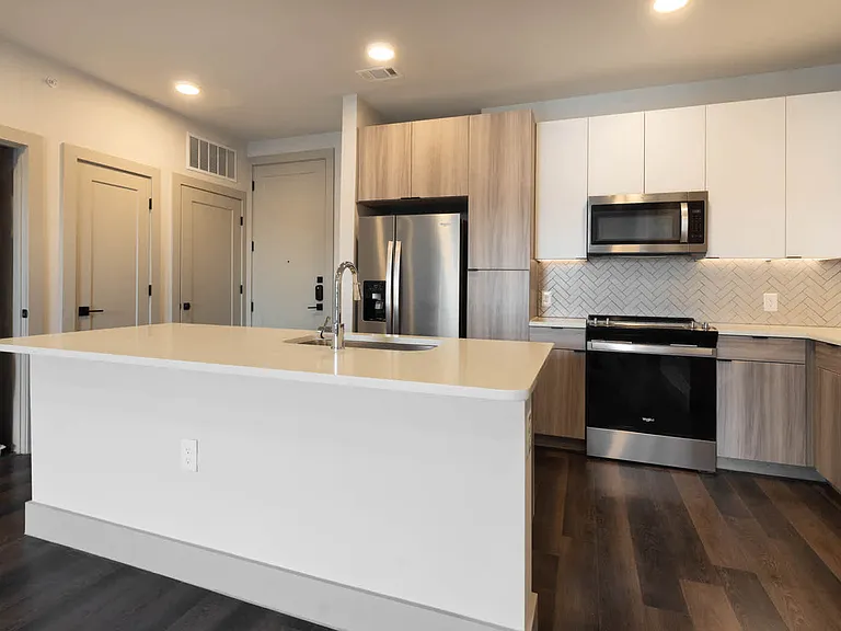 Kitchen with Stainless Steel Appliances and In-home Washer and Dryer