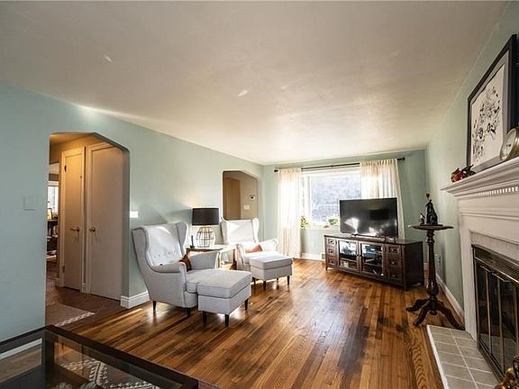 Living room with entrances from entry and kitchen.